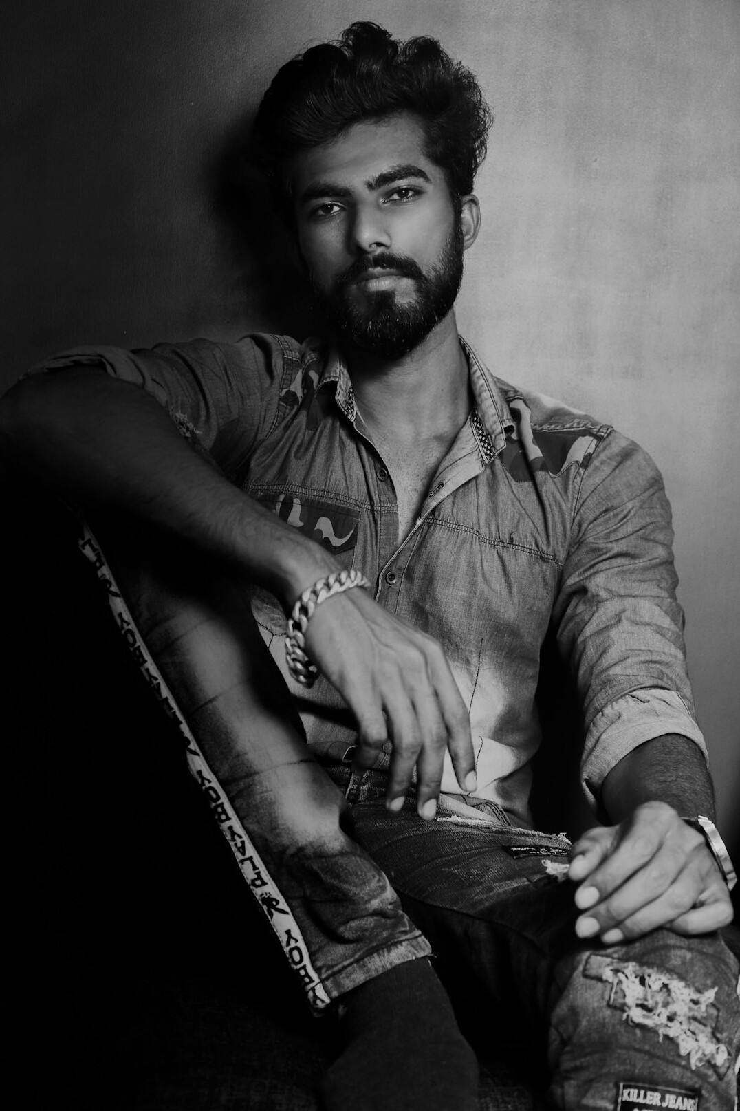 Studio portrait of a man with a beard and glasses
