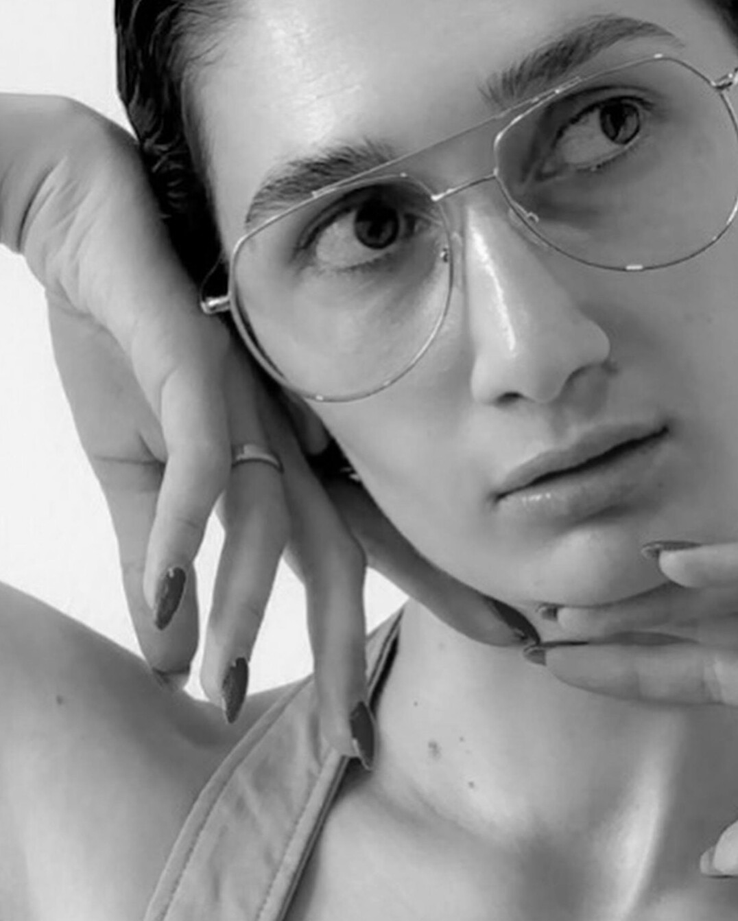 Studio portrait of a man with short hair wearing glasses