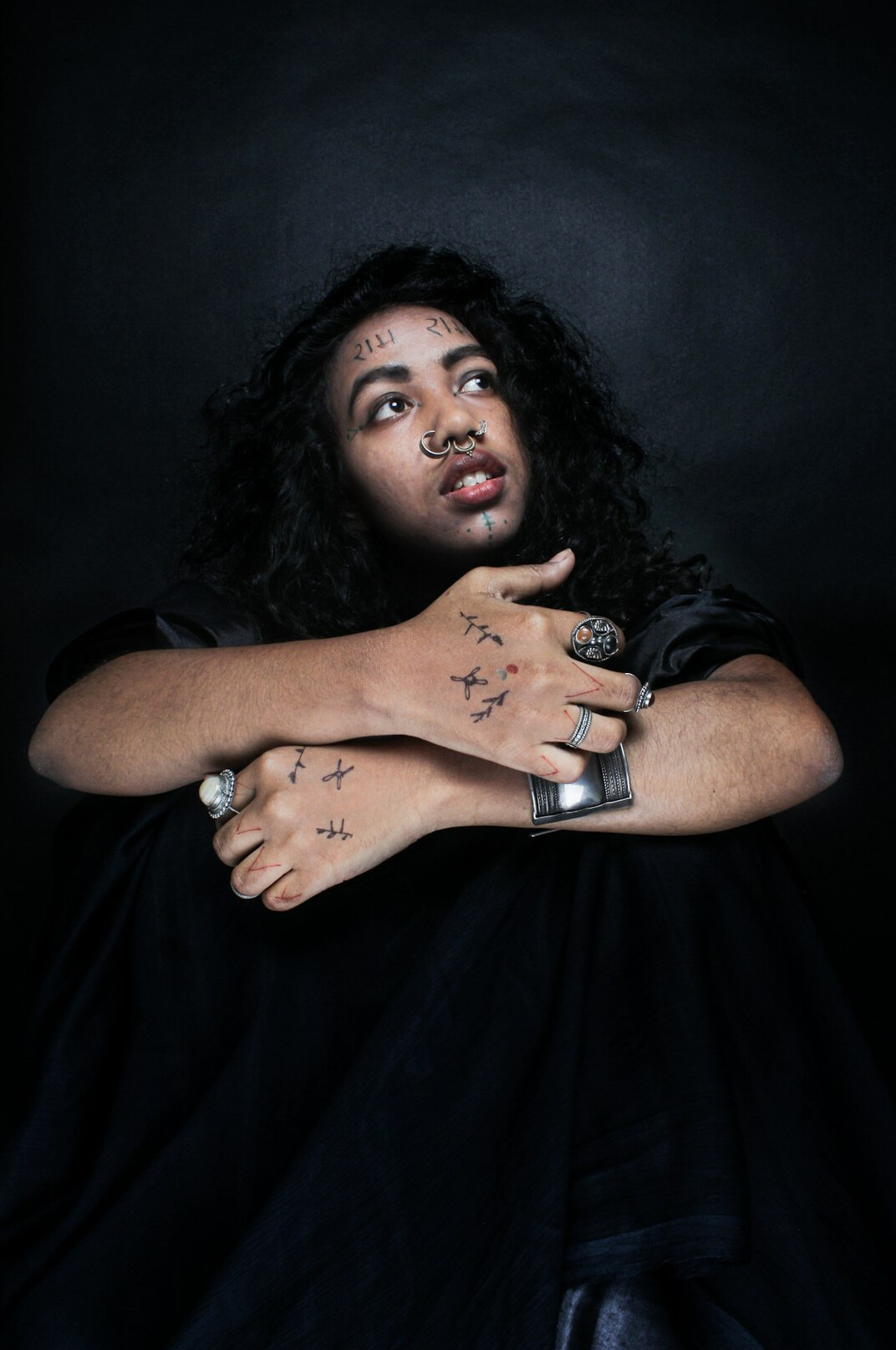 Studio portrait of a woman with curly hair smiling