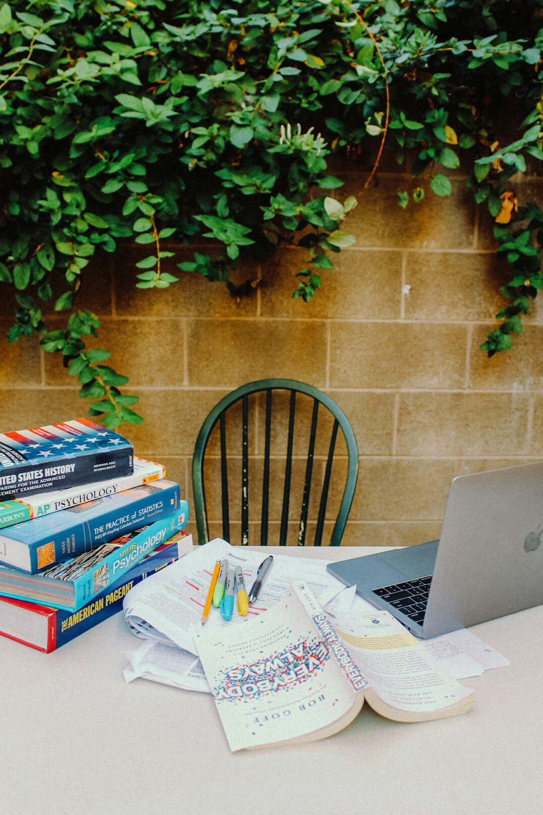 books and laptop on desk